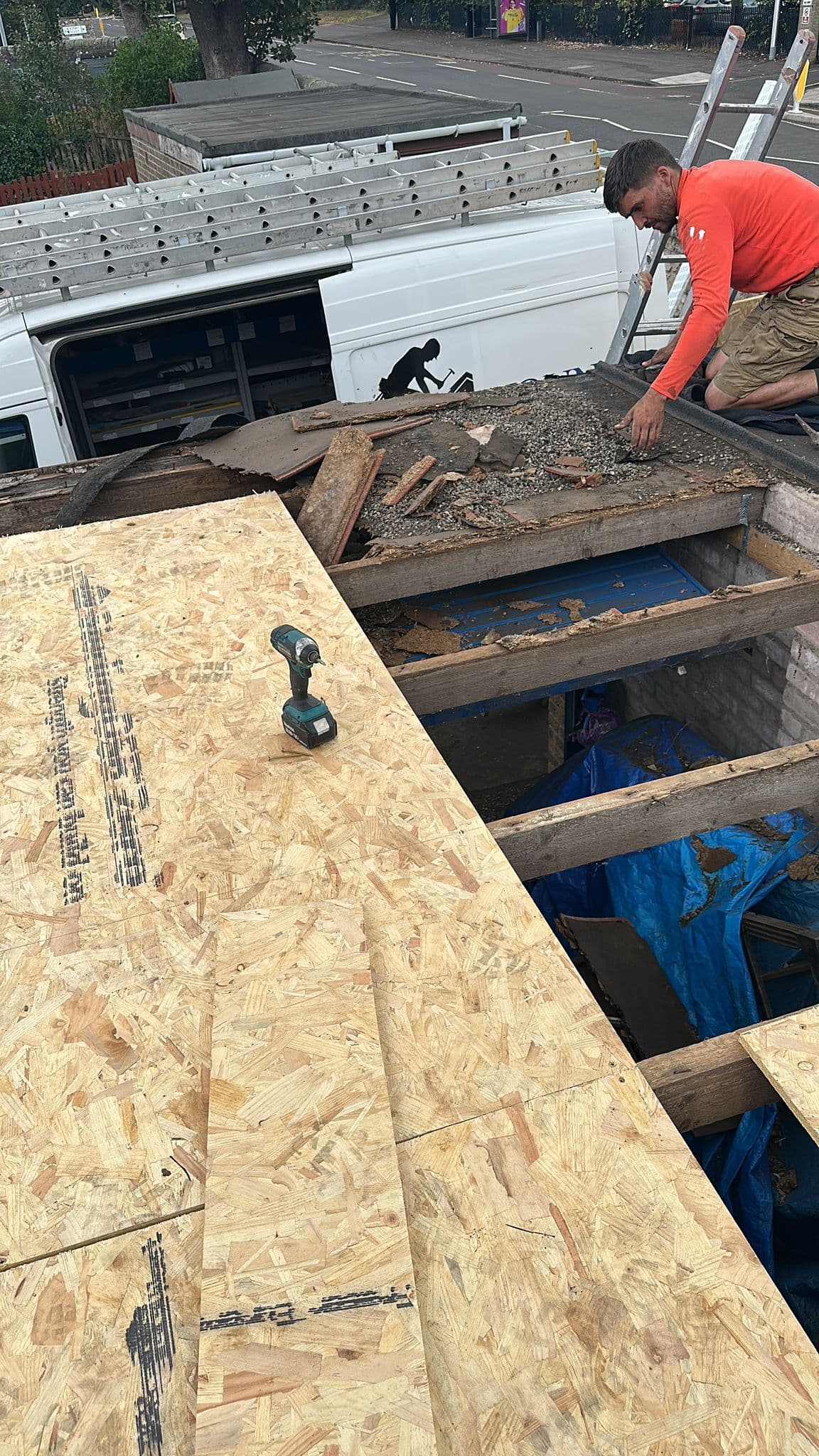 Youngs roofer laying a new flat roof deck